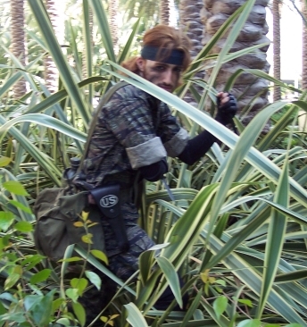 A military guy hidden in the bush.