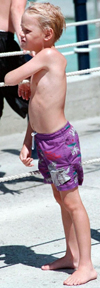 A boy in a swim suit.