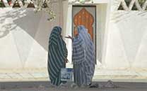 women at short talk on a road of Ghadames