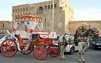 Front pic,coach in front of Tripoli castle in  Green Square.Back pic,pots in the row awaiting clients at tea shop close to Green Square