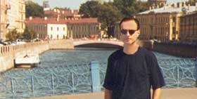 on the background one of the many canals and bridges in city center that justify  for S.Petersburg the surname "Venice of the North"