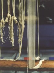 slipping end of warp into slots