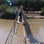 Sheila crossing San Juan on footbridge
