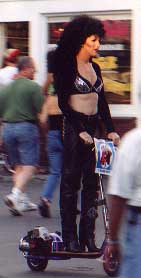 Cher in drag on a motorized scooter, now that's Provincetown