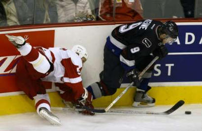 Nicklas Lidstrom falls in pursuit of Mike Keane (photo by Andy Clark/Reuters)
