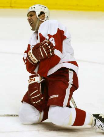 Chris Chelios not long after Todd Bertuzzi landed on his arm (photo by Andy Clark/Reuters)