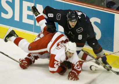 Marek Malik pushes Mathieu Schneider onto Tomas Holmstrom (photo by Andy Clark/Reuters)