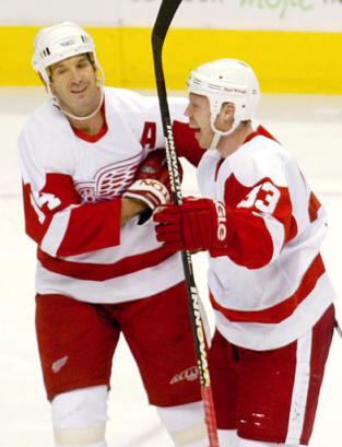 Brendan Shanahan congratulates Kris Draper on his goal which gave the Red Wings their only lead of the night at 2-1 (photo by Richard Lam/AP)