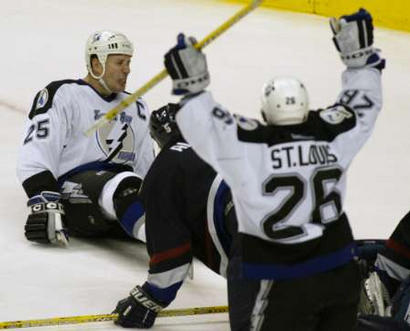 Dave Andreychuk is knocked to the ice by Bryan Allen after scoring a goal.  Martin St. Louis celebrates