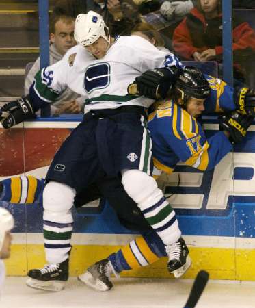 Wade Brookbank throws a check on Ryan Johnson