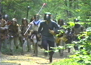 Scouts and fighters charge in this vidcap of the start of the woods battle at Pennsic XX (20) video documentary