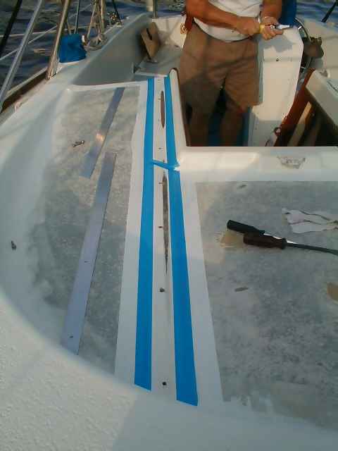 Areas where we will put epoxy filler is taped off, aluminum strips cut to the right size to the left
