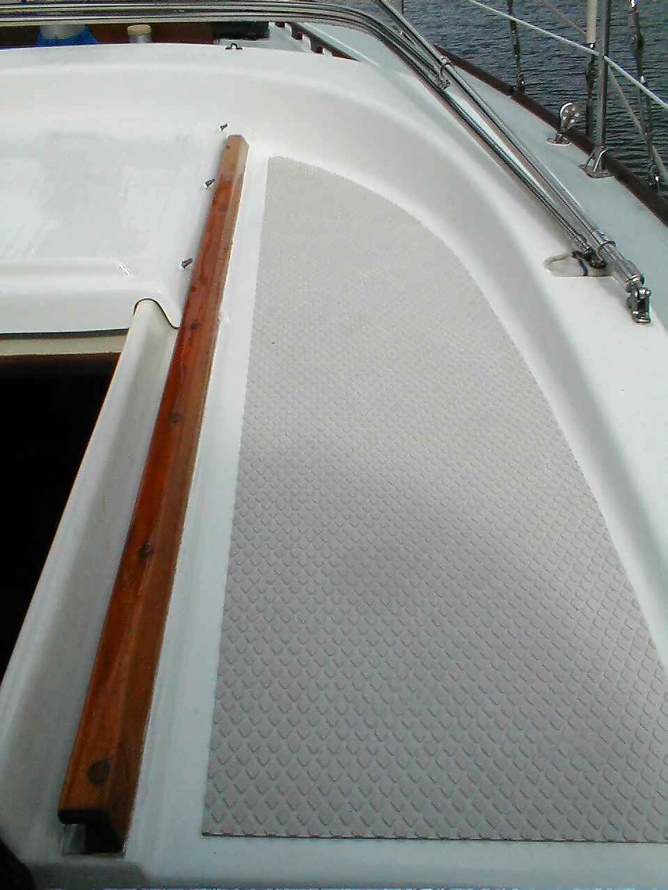 Shows reinstallation of teak pieces and treadmaster.