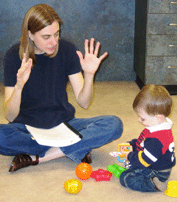 Heather Gartner, instructor, teaching a sign to a child