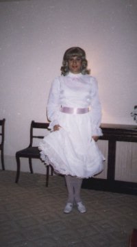 My first party dress, white satin with a pink ribbon tied at the waist