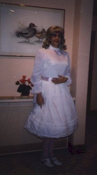 My first party dress, white satin with a pink ribbon tied at the waist