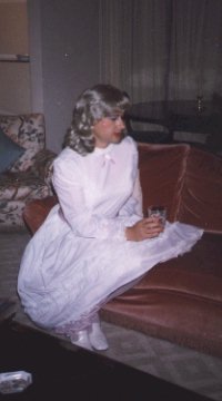 My first party dress, white satin with a pink ribbon tied at the waist