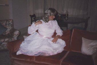My first party dress, white satin with a pink ribbon tied at the waist