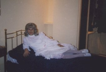 My first party dress, white satin with a pink ribbon tied at the waist