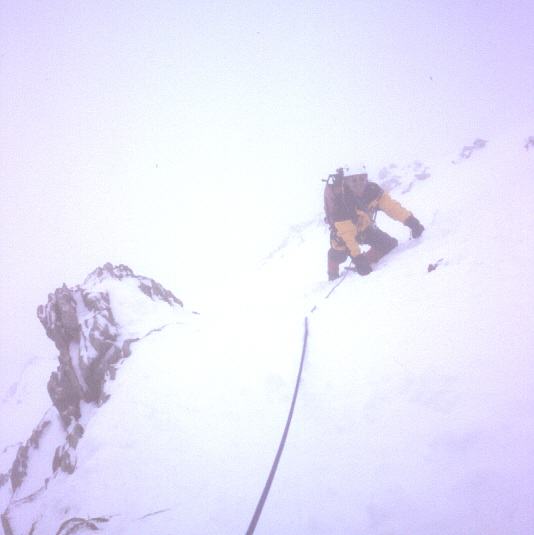 Dr Kung climbing in complete white-out on the SE ridge of the Monch, Bernese Oberland 1998.
