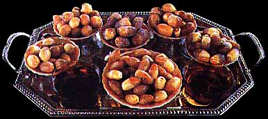 platter of dates, a favored food of the Irekei, along with two cups of qawha or coffee