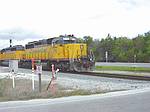 An FEC freight passes the Lewis Speedway crossing in front of the SJC Courthouse.