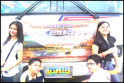 with aika, jing-jing and dave standing and sitting proud at the front of the bus