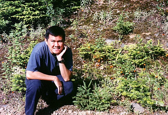 Yin Choy sits among the plants, June 26th 2001