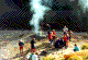 [Photo: Campfire on the river bank]