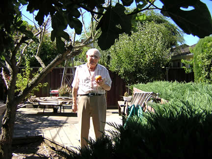 Dad is showing an apple from a tree planted from a seed  a few years ago.  Dad's apple tree planted from a seed a few years ago, It produced a big box of apples in 2003.