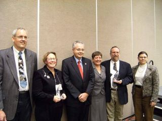 Bayliss Public Library Receives Citation of Excellence Award.  Bayliss Director Ken Miller, with trophy, is 2nd from right. 